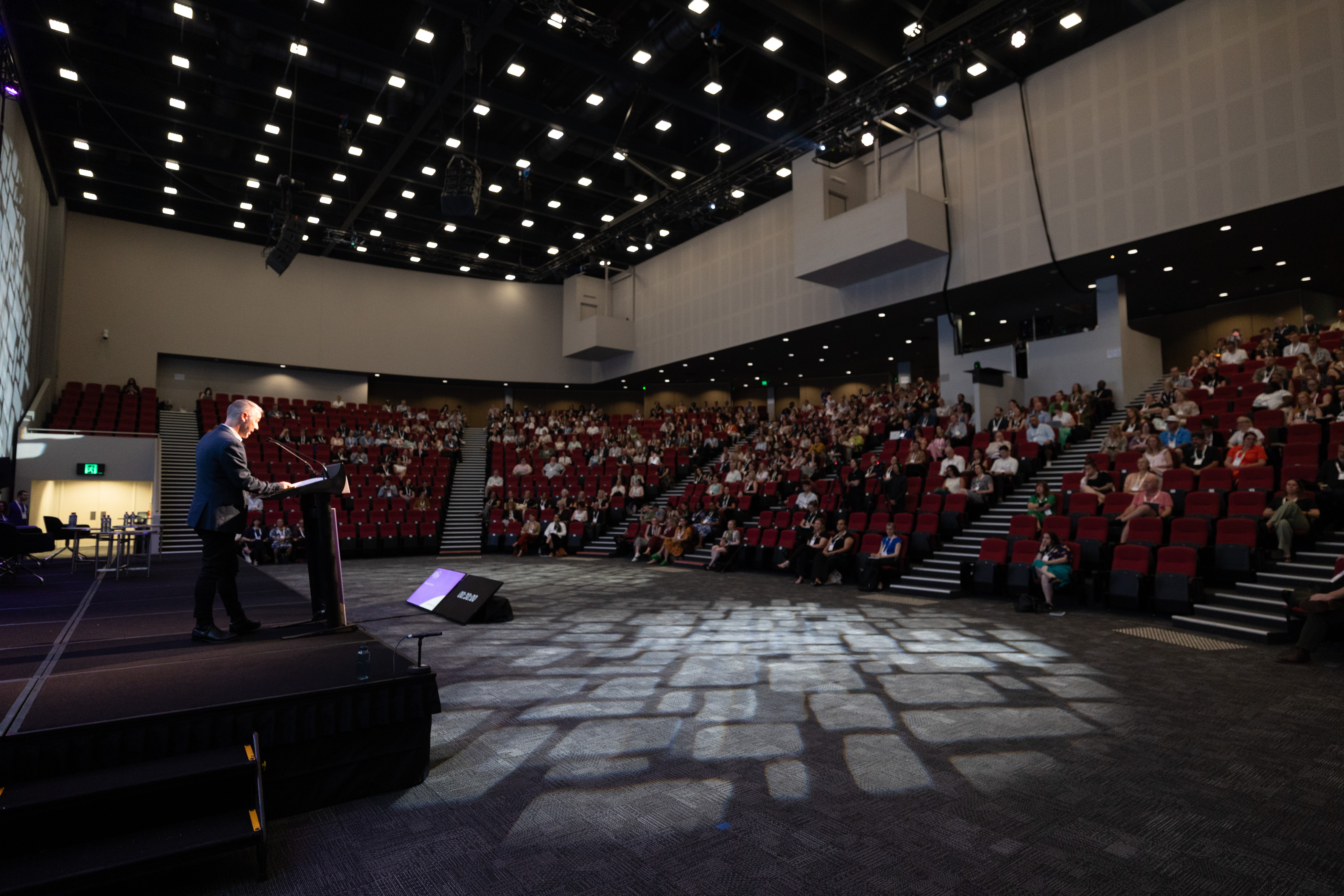 Dr Tom Alves delivering closing address at Australian Homelessness Conference 2026