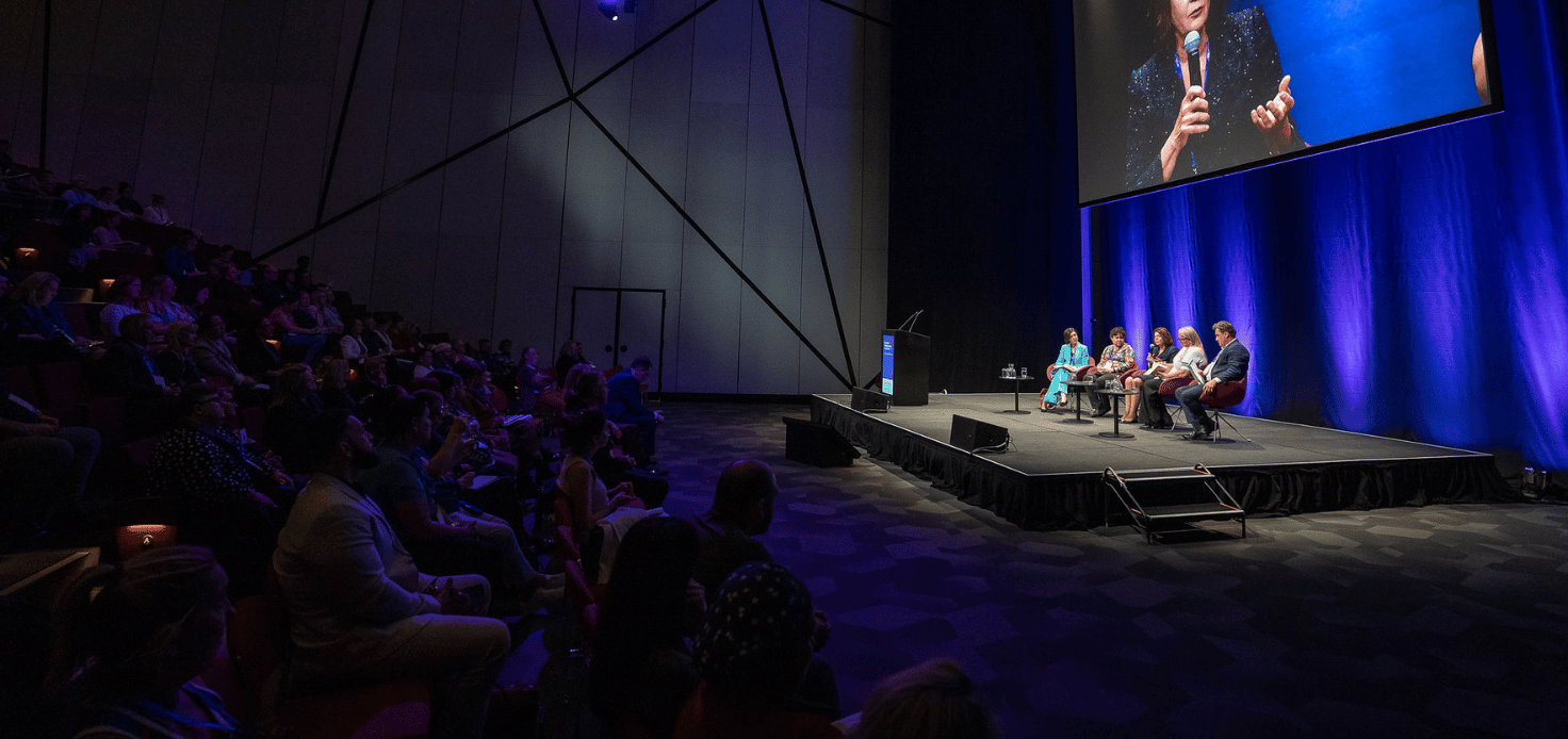 Wide view of panel on stage at Australian Homelessness Conference 2024